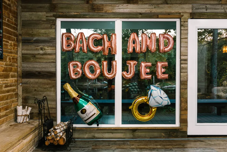 Rose gold balloons spelling Bach and Boujee at a bachelorette party