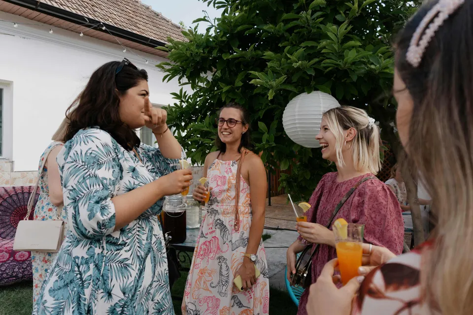 Friends laughing and socializing at an outdoor engagement party