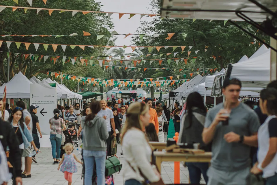 Outdoor festival market with vendor tents and colorful bunting flags