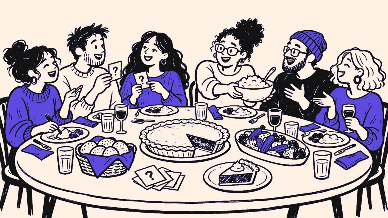 Six friends playing paper games around a Friendsgiving table filled with pie, bread, vegetables, and drinks